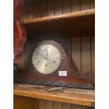 A mantel clock with key.