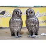 A pair of silver plated sugar castors or pepperettes modelled as owls, height 14cm each.