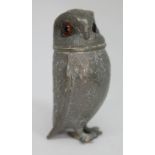 A novelty pewter pepper pot modelled as an owl with glass eyes, height 75mm.