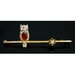 A diamond set bar brooch with enamel owl and set with a red stone, marked '9kt', gross wt. 2.57g,