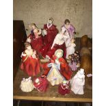 A collection of 12 Royal Doulton lady figurines, various sizes.