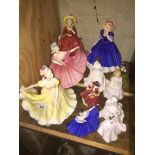 A collection of 11 Royal Doulton lady figurines, various sizes.