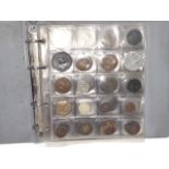 A folder containing over 50 coins and tokens etc