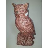 A large pink glazed pottery owl.