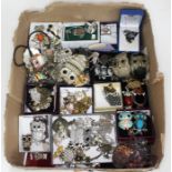 A box of assorted owl costume jewellery.