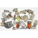 A quantity of silver and white metal owl brooches and badges.