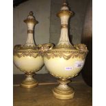 A pair of Royal Worcester blush ivory lidded vases.