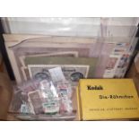 A box containing WWII German banknotes, coins, various stamps and vintage Berlin slides.