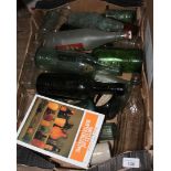 A box of old bottles and a bottle collecting book.