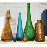 A group of four vintage Italian bottles with stoppers.