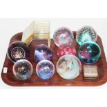 A group of seven Caithness glass paperweights, a miniature Caithness paperweight, another signed
