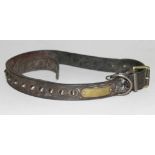 An antique studded leather dog collar.