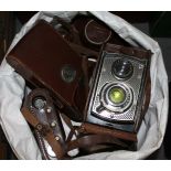 A group of four cameras comprising a Rolleicord, a Zeiss Ikon and two others.