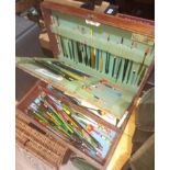 A wooden box containing over 100 various stick floats, some vintage.