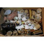 A box of crested ware alongside two cow creamers and a Shelley dish.