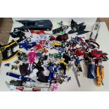 A box of various Batman, Power Rangers and Transformers toys.