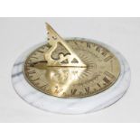 A brass sun dial on marble base, diam. 13.5cm.