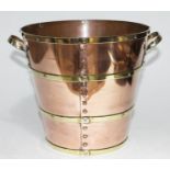 A brass bound and riveted copper ice bucket, height 21cm.