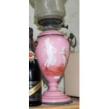 A Victorian pink glass oil lamp with gilt brass fittings and etched glass shade, height 54cm.