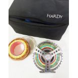 A Hardy Demon 9000 fly fishing reel, loaded with fly line, with padded case and a spool of fly