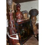 A mixed lot comprising a stained glass panel, two carved wooden heads and a carved wooden lamp.