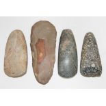 Three Mesolithic hand axes and a flint axe head, lengths 10cm to 14.5cm.