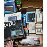 A box of assorted vintage electronics.