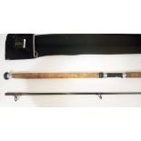 A Daiwa 11ft carbon two part Whisker spinning rod, casting weight 10-60g, with rod bag. Good