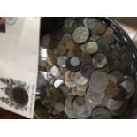 A tin of world coins