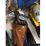Golf bag and clubs, some with hickory / cane shaft.