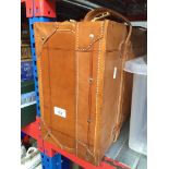 A vintage brown leather and fitted suitcase - code to open the case is left side 686 and right