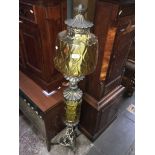 An electrified brass and glass floor standing oil lamp, height 140cm.