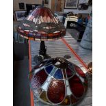 A Tiffany style lamp with dragonfly design shade and a leaded glass ceiling light fitting.