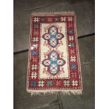 Vintage Turkish red ground carpet, 95cm x 59cm.
