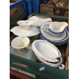 A box of various dishes including cake stand and trays