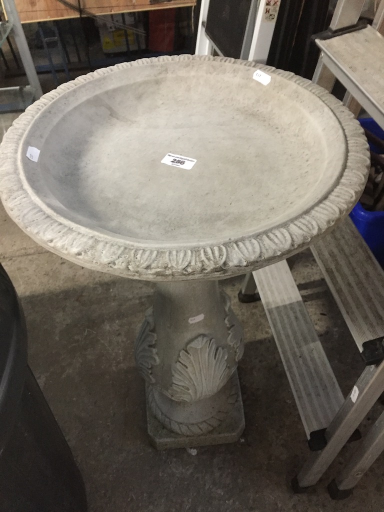 A concrete bird bath.