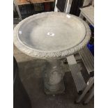 A concrete bird bath.