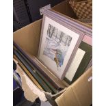 A box containing a selection of cross stitch pictures