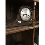 An oak cased mantle clock