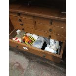 A wooden multidrawer cabinet - no key, containing various haberdashery items.