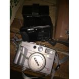 A Canon PowerShot G2 camera, a Panasonic Lumix DMC-TZ40 camera and Tasco folding binoculars.