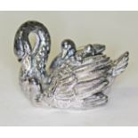 An imported silver filled paperweight modelled as a swan and cygnets, length 7cm.