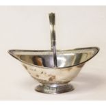 An Edwardian silver pierced pedestal based bon bon dish with swing handle, William Hair Haseler,