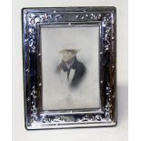 A hallmarked silver photograph frame, height 18cm.