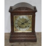 A carved oak mantel clock, circa 1900, striking on double gong, height 33cm.