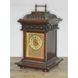 A late 19th century carved oak mantle clock, the top with hinged lid revealing a polyphon music