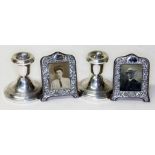 Hallmarked silver comprising a pair of miniature photograph frames and a pair of candle stands.