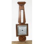 An Art Deco inlaid walnut aneroid barometer, signed Clarke & Ainsworth Blackpool, length 57cm.