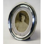 An oval hallmarked silver photograph frame, height 22cm.