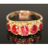 A hallmarked 9ct gold ring set with garnet topped doublets, gross weight 2.23g, size P.